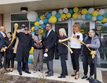 Local officials pose for a ribbon-cutting at an affordable housing cvomplex