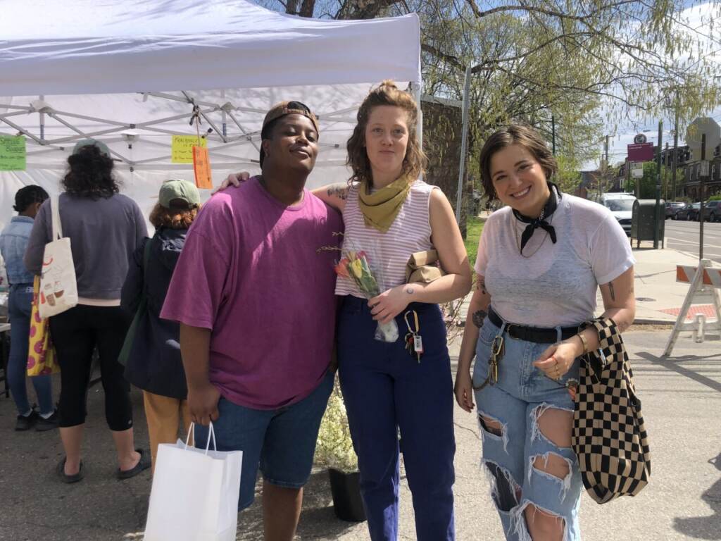 (from left) Al Bland, Anna Armstrong, and Kai Yohman, of West Philadelphia, enjoying the Clark Park farmer’s market on Saturday afternoon. (Emily Rizzo/WHYY News)