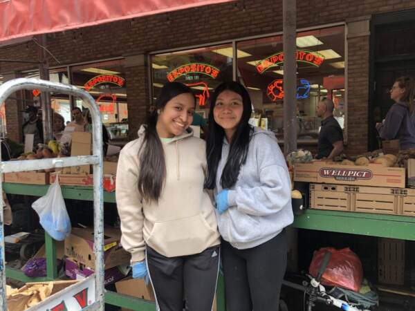 Bryana Corona and her sister are working at their family’s stand, Charlie's, in the Italian Market. Corona said her family plans to grill steak outside to celebrate Easter this weekend. (Emily Rizzo/WHYY News)
