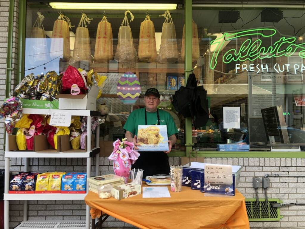 Michael Brown, of Talluto’s, selling ricotta pie and Torrone candy in the Italian market on Saturday. He said the market was busier than it has been compared to the last two Easter weekends. (Emily Rizzo/WHYY News)