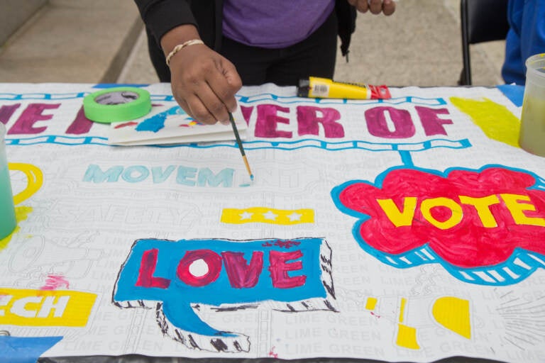 An art project is seen with the words ''vote'' and ''love'' visible