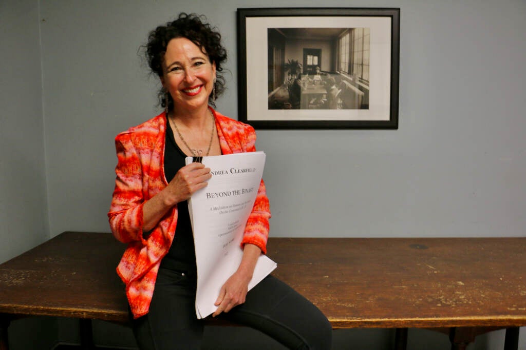 Composer Andrea Clearfield holds her score for ''Beyond the Binary.'' The choral work will premiere at the Filmore to celebrate the 100th anniversary of the word ''robot.''