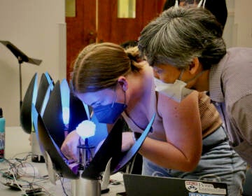 Penn GRASP Lab student Lilian Stoesser works on a robotic flower that is programmed to open and close in response to the music of ''Beyond the Binary.''