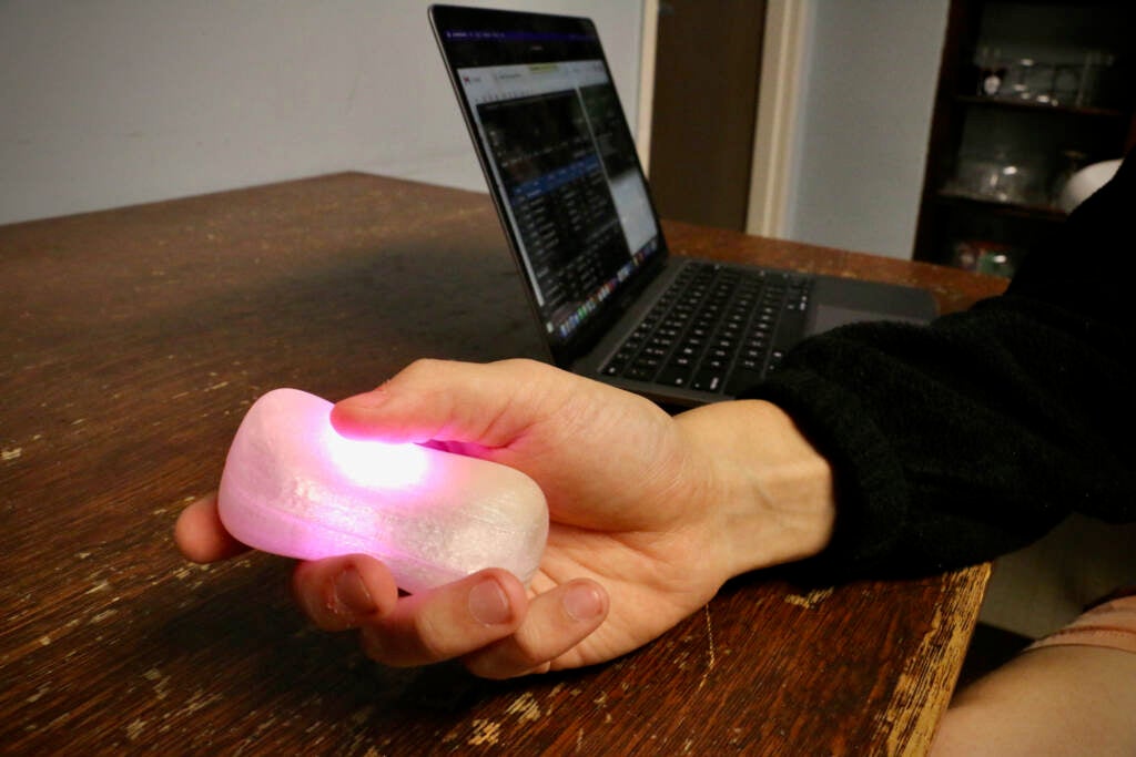 Penn GRASP Lab student Noam Aizenberg holds one of fifty devices that will be used for dynamic crowd lighting during the performance of ''Beyond the Binary.''