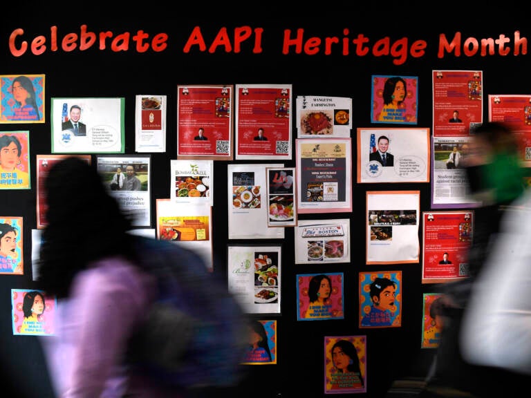 Students walk past a display for Asian Pacific American Heritage Month