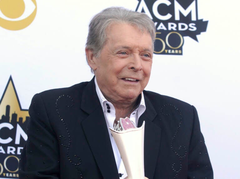 In this April 19, 2015 file photo, Mickey Gilley poses with the triple crown award on the red carpet at the 50th annual Academy of Country Music Awards at AT&T Stadium in Arlington, Texas. Country music artist Gilley and his son were injured in a car accident in Texas, but both are recovering after minor injuries. A statement from Gilley's publicist on Thursday, Jan. 4, 2018, said the two were injured Wednesday when their car rolled over. (Photo by Jack Plunkett/Invision/AP, File)