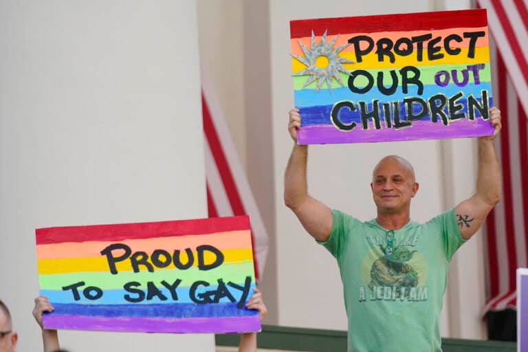 Demonstrators gather on the steps of the Florida Historic Capitol Museum in front of the Florida State Capitol, Monday, March 7, 2022, in Tallahassee, Fla. (AP Photo/Wilfredo Lee)