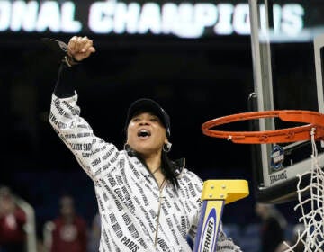 South Carolina head coach Dawn Staley reacts while cutting the net following a college basketball game against Creighton in the Elite 8 round of the NCAA tournament in Greensboro, N.C., Sunday, March 27, 2022. (AP Photo/Gerry Broome)