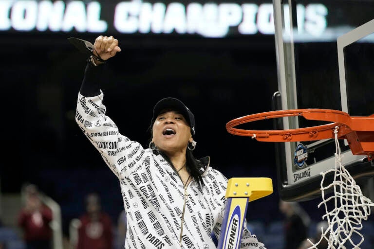 South Carolina head coach Dawn Staley reacts while cutting the net following a college basketball game against Creighton in the Elite 8 round of the NCAA tournament in Greensboro, N.C., Sunday, March 27, 2022. (AP Photo/Gerry Broome)