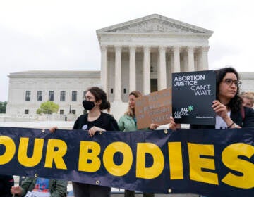 Demonstrators protest outside of the U.S. Supreme Court Tuesday, May 3, 2022 in Washington. (AP Photo/Jose Luis Magana)