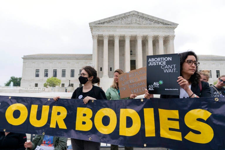 Demonstrators protest outside of the U.S. Supreme Court Tuesday, May 3, 2022 in Washington. (AP Photo/Jose Luis Magana)