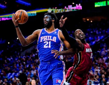 Philadelphia 76ers' Joel Embiid (21) and Miami Heat's Bam Adebayo battle for the ball during the first half of Game 3 of an NBA basketball second-round playoff series, Friday, May 6, 2022, in Philadelphia. (AP Photo/Matt Slocum)