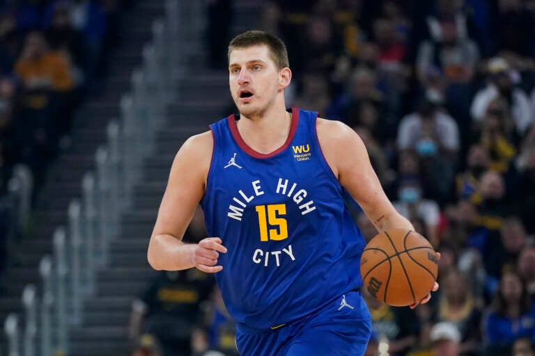 Denver Nuggets center Nikola Jokic (15) dribbles the ball up the court against the Golden State Warriors during the first half of Game 2 of an NBA basketball first-round playoff series in San Francisco, Monday, April 18, 2022. (AP Photo/Jeff Chiu)