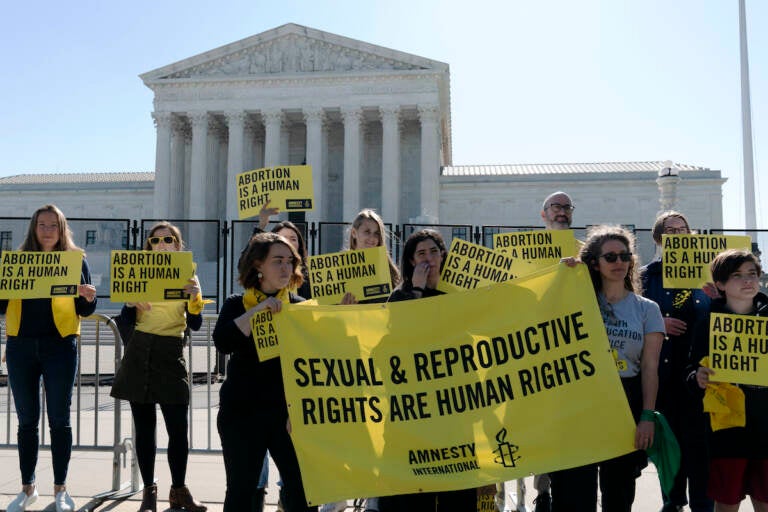 Abortion rights activists protest outside of the U.S. Supreme Court, Wednesday, May 11, 2022 in Washington. A draft opinion suggests the U.S. Supreme Court could be poised to overturn the landmark 1973 Roe v. Wade case that legalized abortion nationwide, according to a Politico report