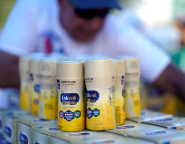 Infant formula is stacked on a table during a baby formula drive to help with the shortage Saturday, May 14, 2022, in Houston. (AP Photo/David J. Phillip)