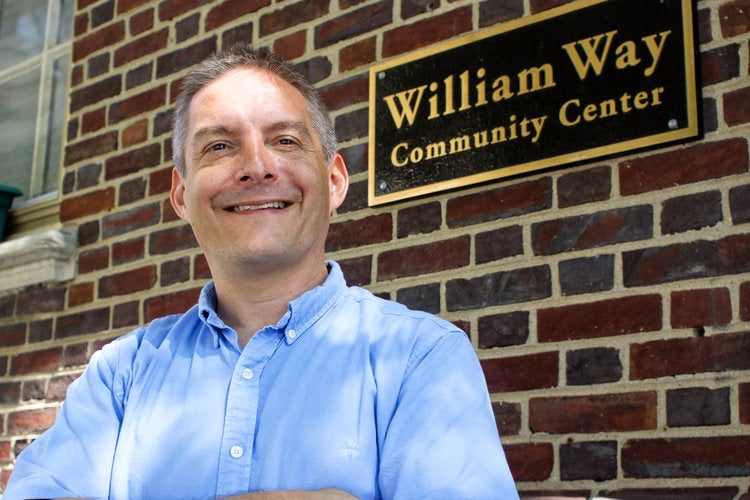Chris Bartlett poses for a photo in front of the William Way Center.