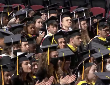 Temple University Class of 2022 graduates applaud in response to a speaker.