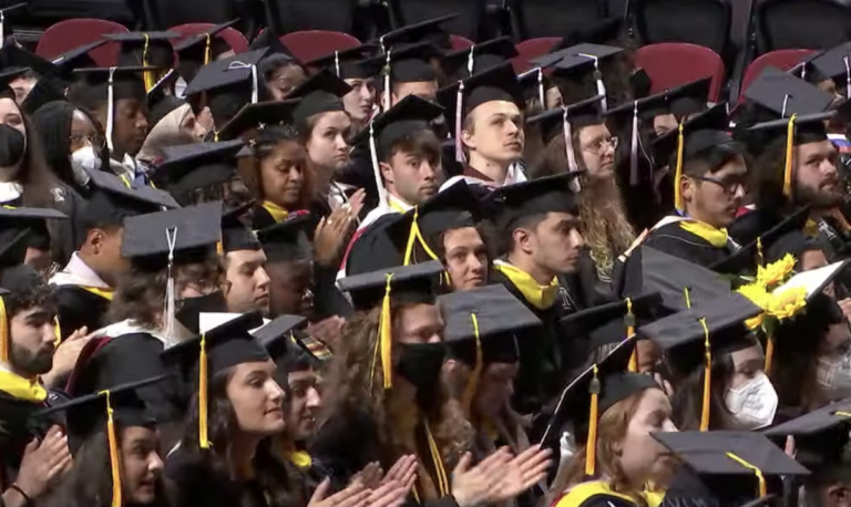 Temple University Class of 2022 graduates applaud in response to a speaker.