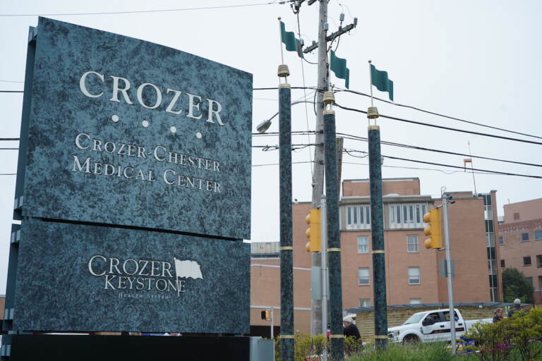 A sign for Crozer Health is visible in the foreground, with buildings in the background.