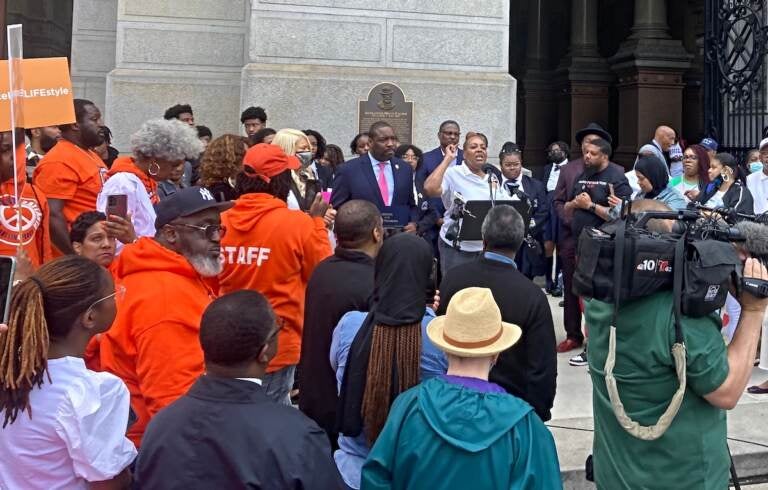 Interfaith leaders, youth mentors, law enforcement representatives and elected officials spoke at an anti-gun violence rally at City Hall Thursday. Mothers in Charge, a nonprofit led by mothers who've lost children to gunfire, organized the event. (Sammy Caiola/WHYY)