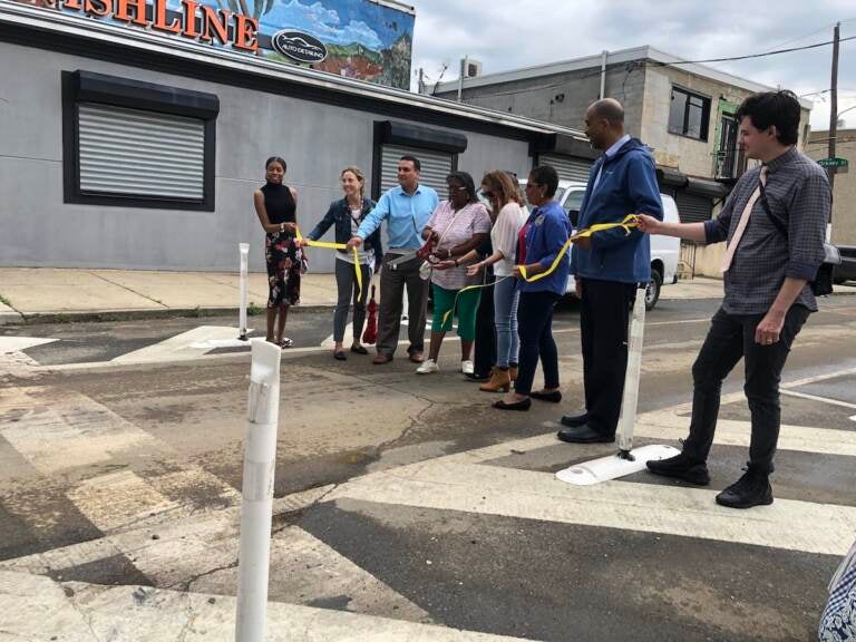 City officials and community members cut the ribbon on the city's first ''slow zone'' in Fairhill. (Sophia Schmidt/WHYY)