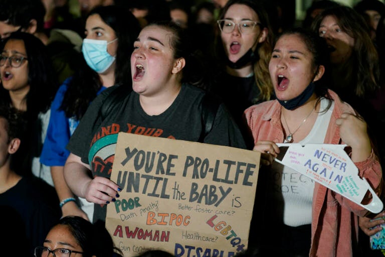 Protesters hold signs in support of Roe v. Wade outside the U.S. Supreme Court