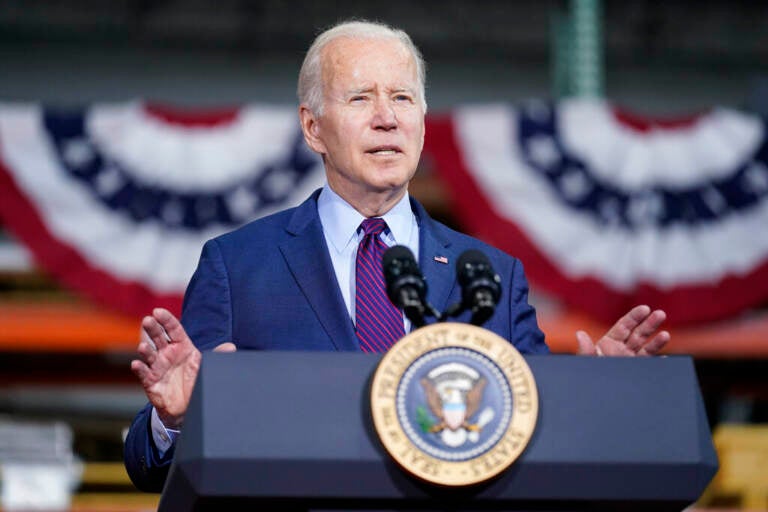 President Joe Biden speaks at a podium.