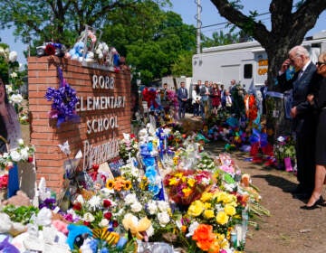 President Joe Biden and First Lady Jill Biden stand in front of a memorial to the victims of the mass shooting in Uvalde, Texas.