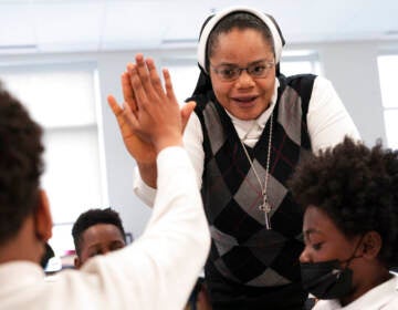 ister Delphine Okoro, a nun with the Oblate Sisters of Providence, high fives a student as she teaches a fifth grade class at Mother Mary Lange Catholic School in Baltimore, Md., Wednesday, April 27, 2022.