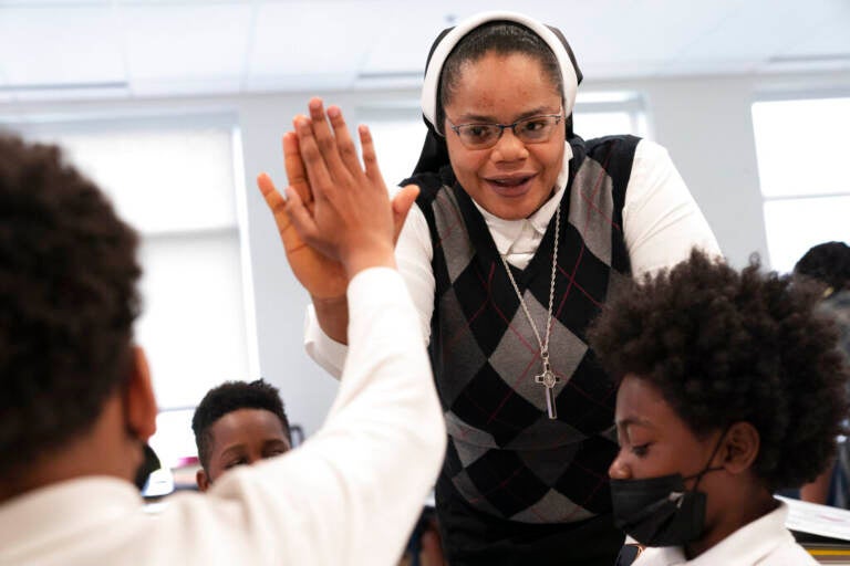 ister Delphine Okoro, a nun with the Oblate Sisters of Providence, high fives a student as she teaches a fifth grade class at Mother Mary Lange Catholic School in Baltimore, Md., Wednesday, April 27, 2022.
