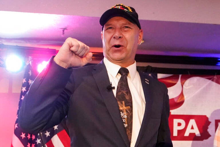 Doug Mastriano raises his fist in celebration after winning the Pa. 2022 GOP primary.