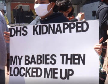 A sign held at an April rally in Love Park after a Philadelphia City Council committee released a report calling for child welfare reform.