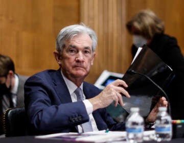 Federal Reserve Chair Jerome Powell collects his notebooks as he testifies before the Senate Banking Committee