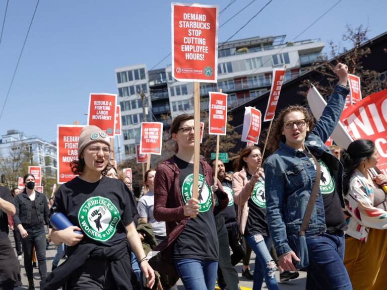 Starbucks union supporters march with signs.