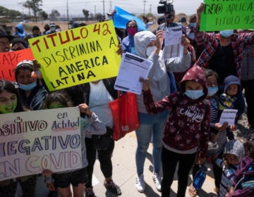 Migrants and asylum seekers protest outside the United States Consulate against the public health order known as Title 42, in Tijuana, Mexico, on May 19, 2022. (Guillermo Arias/AFP via Getty Images)