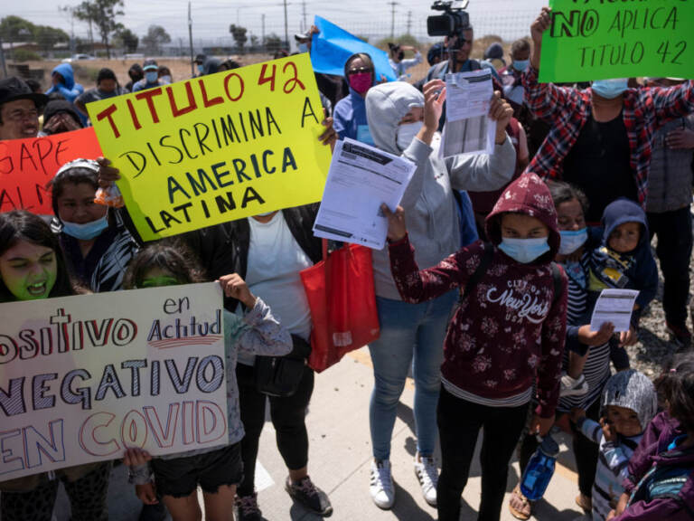 Migrants and asylum seekers protest outside the United States Consulate against the public health order known as Title 42, in Tijuana, Mexico, on May 19, 2022. (Guillermo Arias/AFP via Getty Images)
