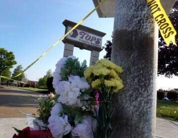 Flowers are left at a makeshift memorial outside of the Tops market on May 15 in Buffalo, N.Y. (Scott Olson/Getty Images)