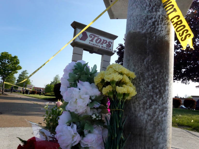 Flowers are left at a makeshift memorial outside of the Tops market on May 15 in Buffalo, N.Y. (Scott Olson/Getty Images)