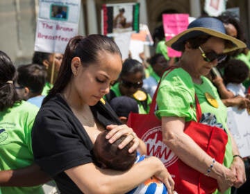 The baby-formula shortage has led some to question why the U.S. doesn't provide more support for breastfeeding. Here, a woman breastfeeds her son outside New York City Hall during a 2014 rally to support breastfeeding in public. (Andrew Burton/Getty Images)