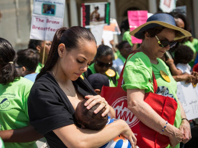 The baby-formula shortage has led some to question why the U.S. doesn't provide more support for breastfeeding. Here, a woman breastfeeds her son outside New York City Hall during a 2014 rally to support breastfeeding in public. (Andrew Burton/Getty Images)