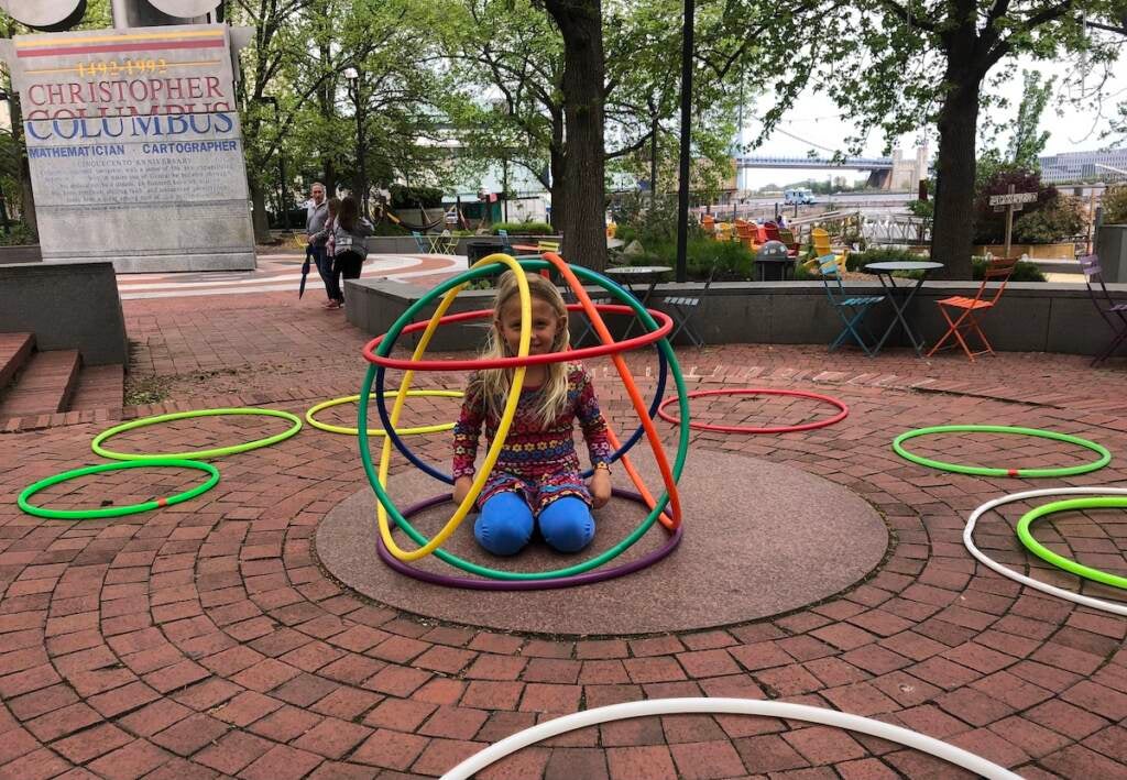 Seven-year-old Pia poses in a hoop hut.