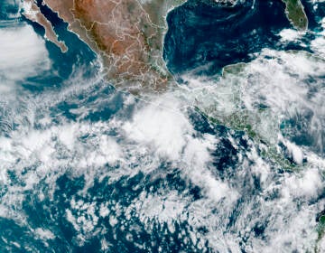 This satellite image made available by NOAA shows Hurricane Agatha, center, off the Pacific coast of Mexico on Sunday, May 29, 2022, at 11:20 a.m. EDT.