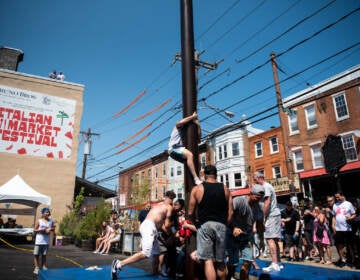 Climbers struggle as their teammates climb on their shoulders during the greased pole competition in Montrose Piazza on Sunday, May 22, 2022.