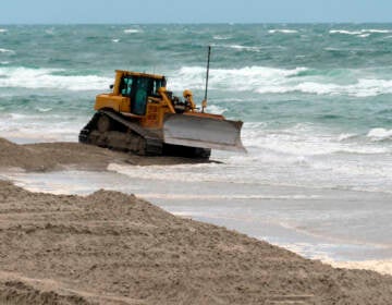 A bulldozer smooths out newly placed sand on an eroded beach in North Wildwood, N.J. on May 24, 2022.  Winter and spring storms caused erosion that will prevent several Jersey Shore beaches from being ready for Memorial Day weekend, but the vast majority of the state's beaches came through the off-season in good condition. (AP Photo/Wayne Parry)