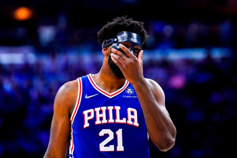 Joel Embiid puts his hand over his face during a playoff game with the Miami Heat.