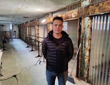 Mark Menjivar stands in the exhibition space at the Eastern State Penitentiary.