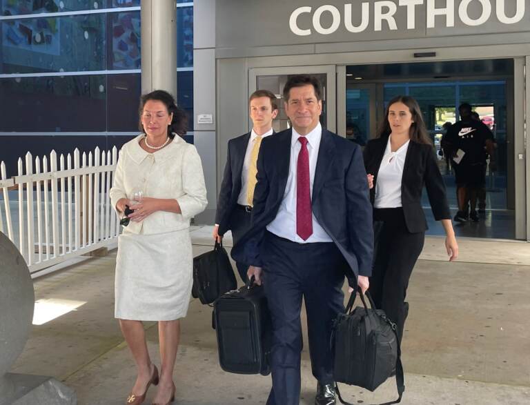 Indicted Delaware auditor Kathy McGuiness (left) leaves Monday's abbreviated court session with defense lawyers Dean Elwell, Steve Wood and Chelsea Botsch.