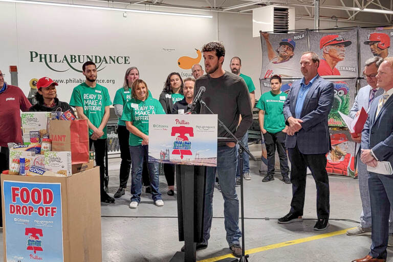 Philadelphia Phillies pitcher Aaron Nola speaking at the event with Philabundance on May 18, 2022. (Tom MacDonald / WHYY)