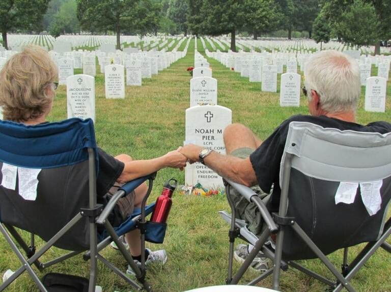 Vikki and Mark Pier visit the grave of their son, Noah, who was buried at Arlington National Cemetery in July 2011. They used to visit every few months, but they have been unable to make it in recent years. (Erin Stalnaker)