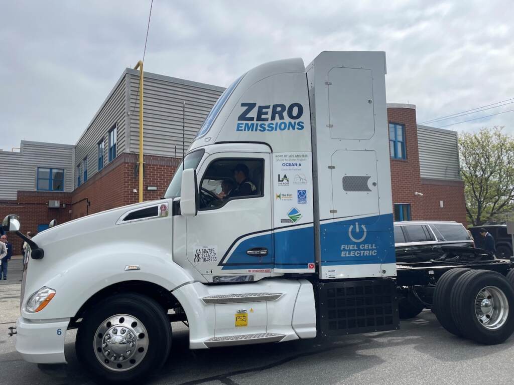 A hydrogen-powered tractor is visible parked in a parking lot.